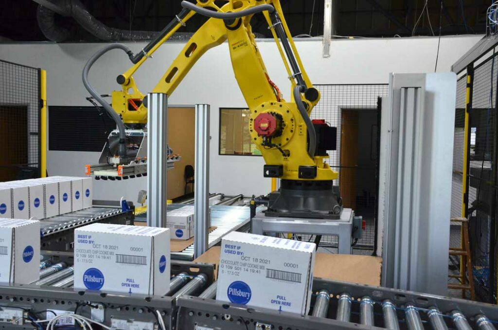 A cobot picking up boxes and moving them onto a pallet