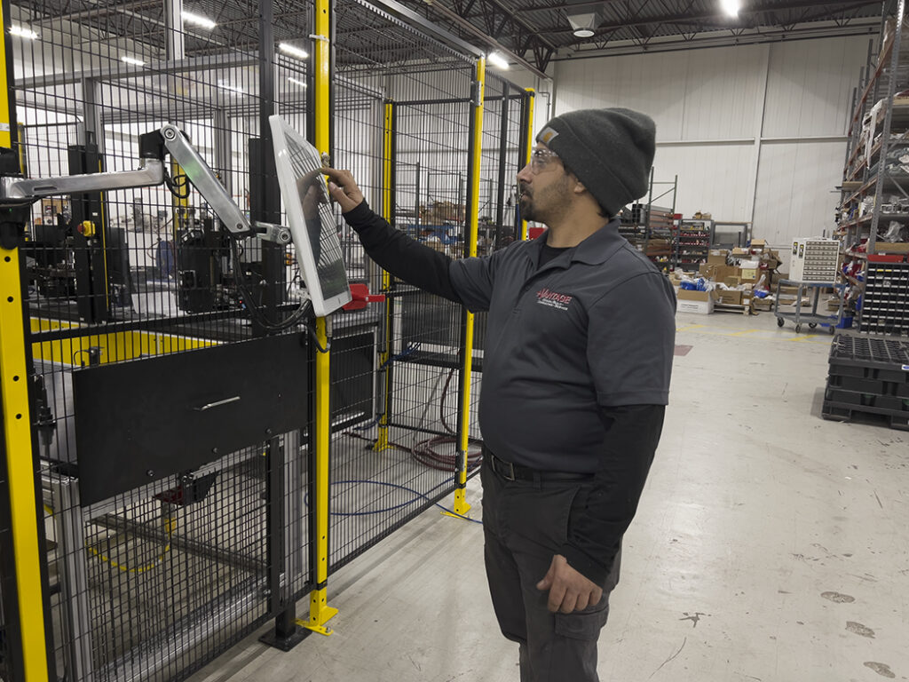 Warehouse employee reviewing a robotic automation system